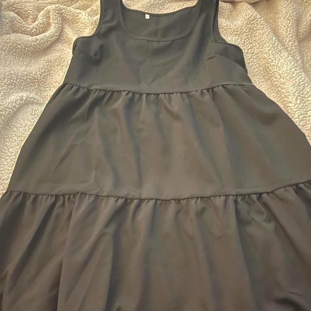 Women’s black tiered maxi swing dress.